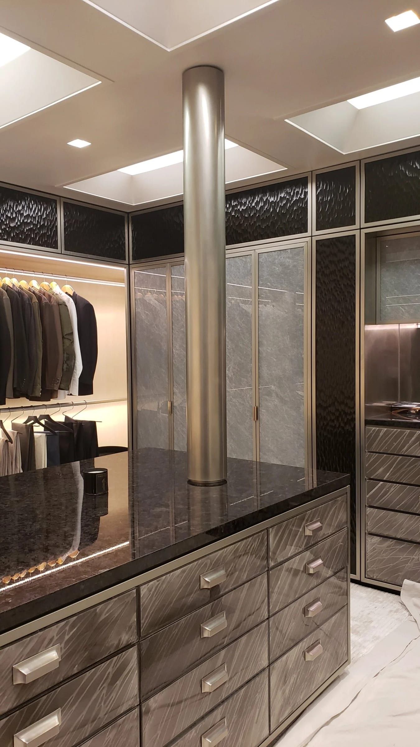 Dressing room with a polished steel column and island