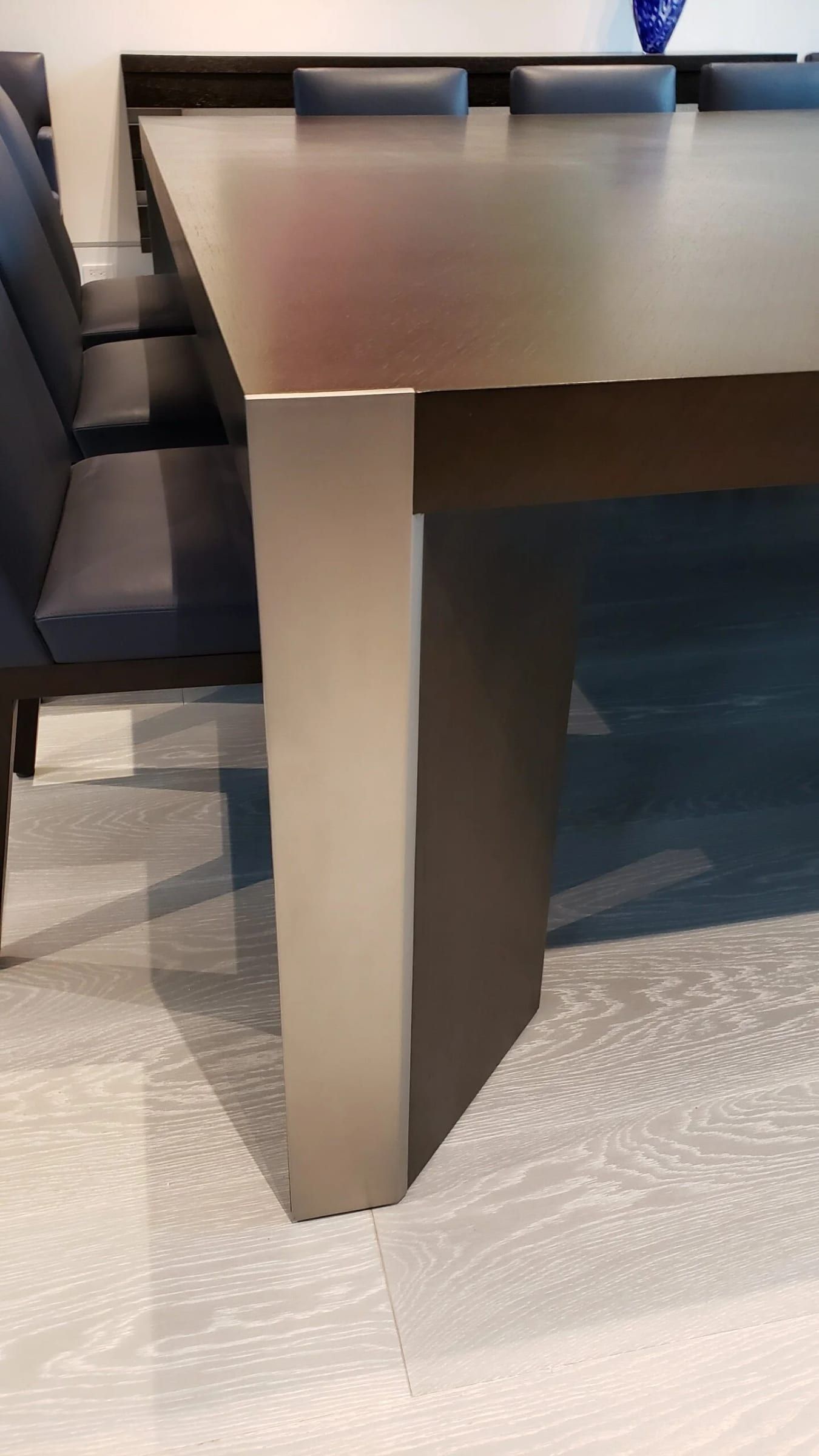 Table leg in a dark metal finish, close detail