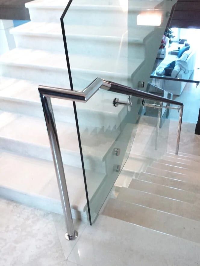 Glass stair balustrade with a stainless steel handrail