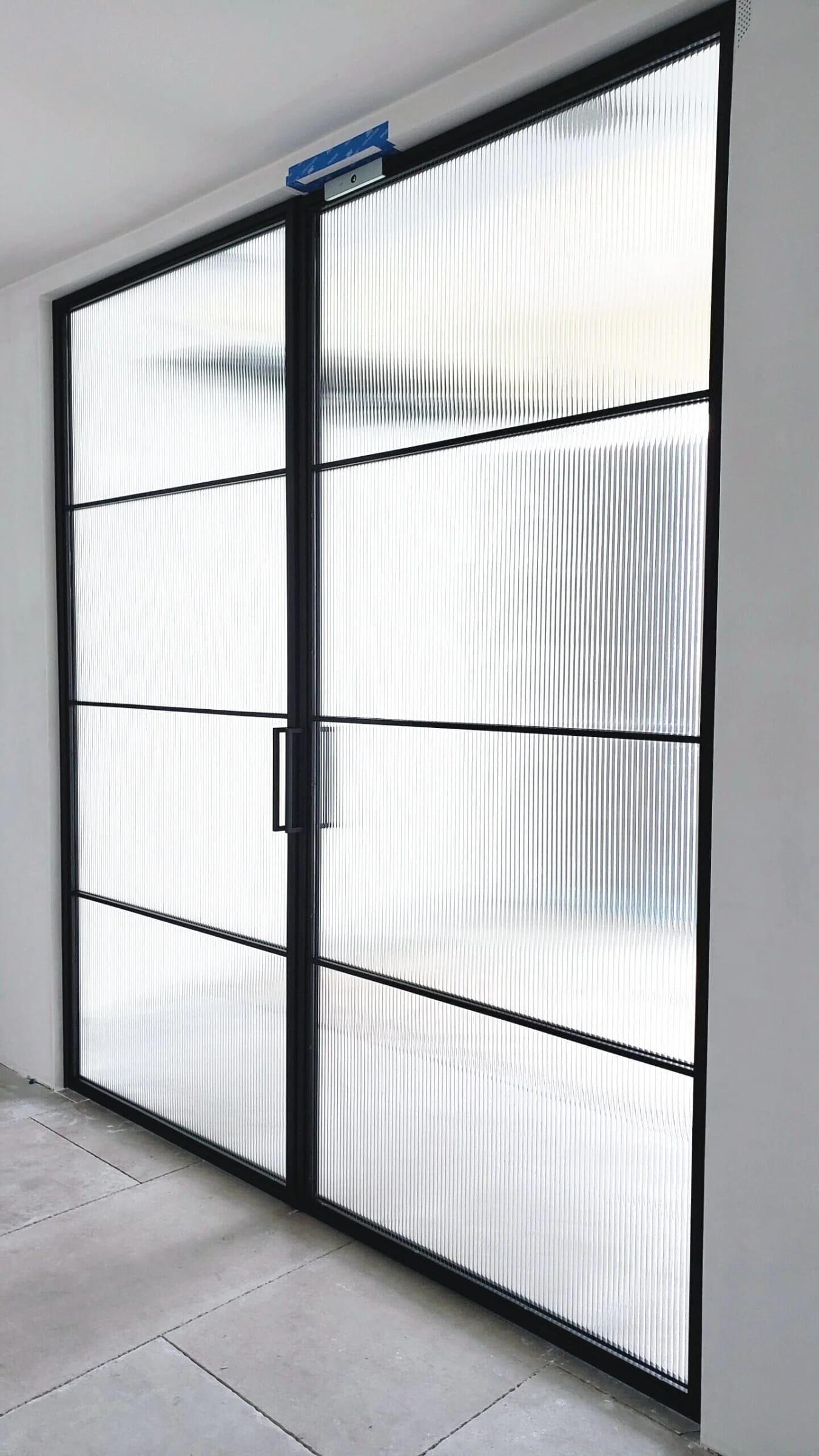 Black powder-coated steel entry door with reeded glass