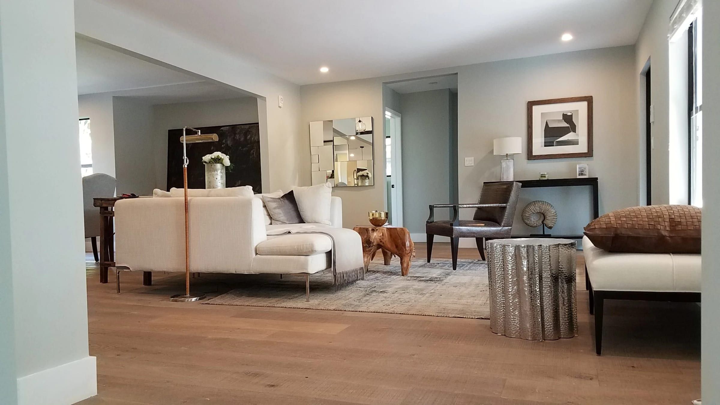 Open living area with a white sectional and lounge chairs